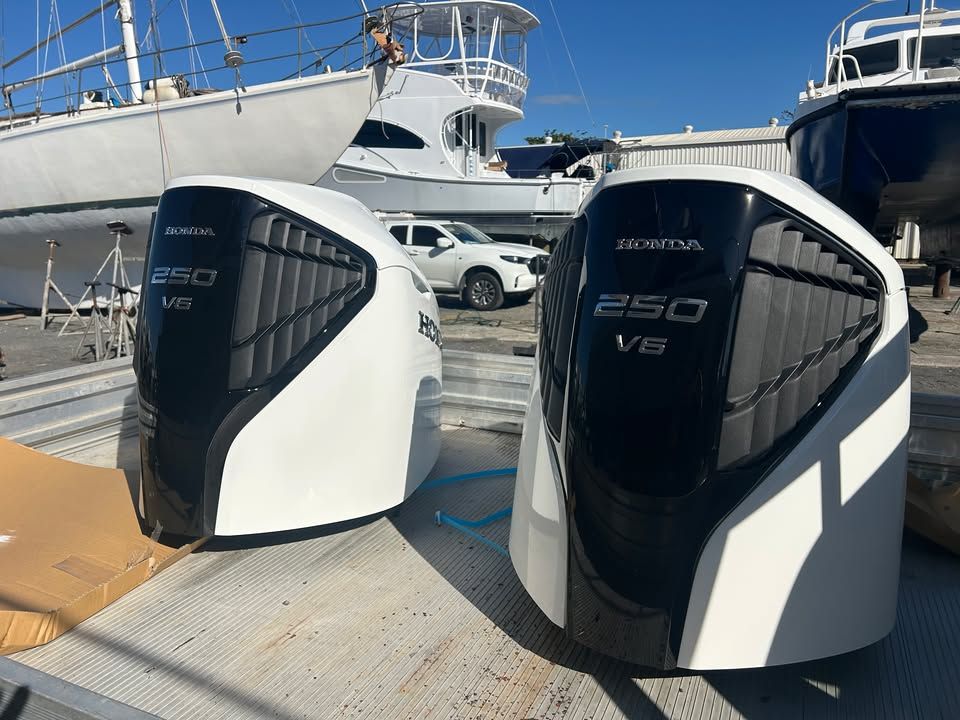 Two White Honda 250 V6 Outboard Motor Cowlings On A Dock