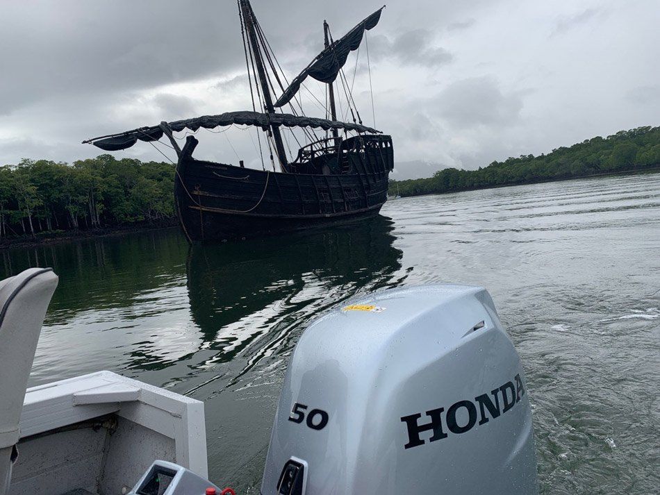 A Boat With A Pirate Ship In The Background And A Honda Outboard Motor In The Foreground — HiTune Marine In Bentley Park, QLD
