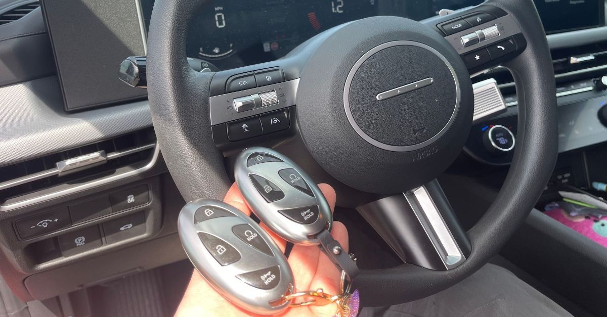 hand holding car key fob