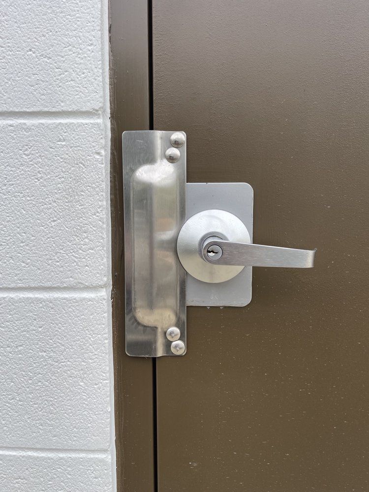 A door with a heavy-duty lock and latch protector
