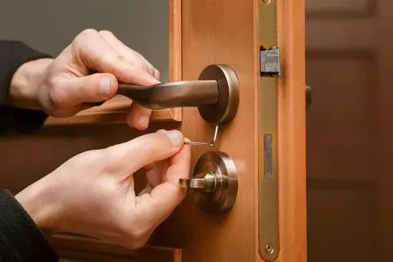 A person is opening a door with a key.