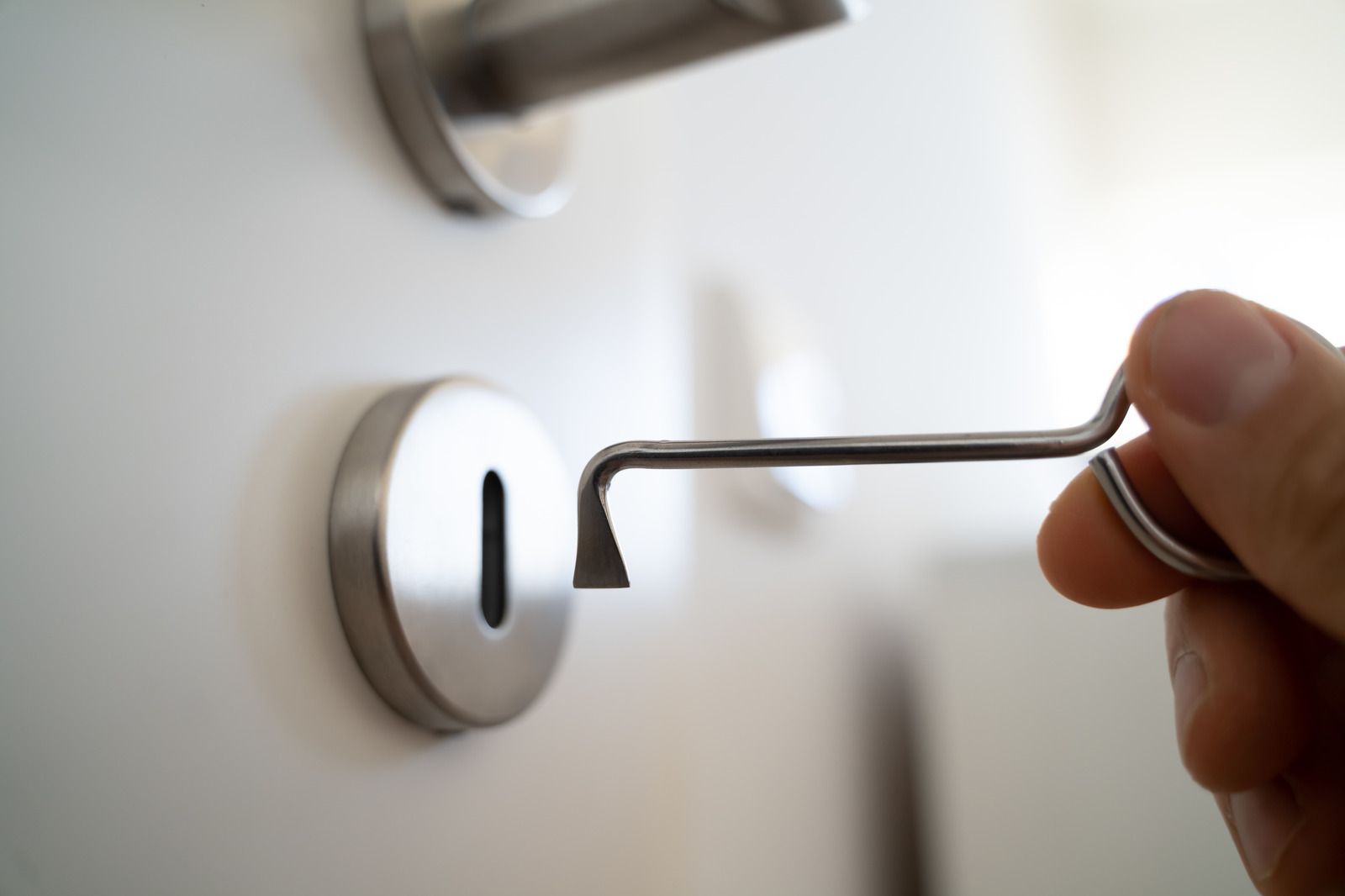 A person is opening a door with a key
