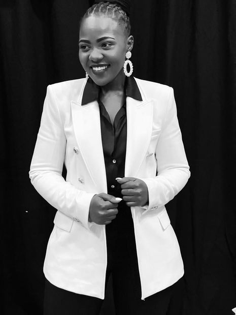 A black and white photo of a woman wearing a white jacket