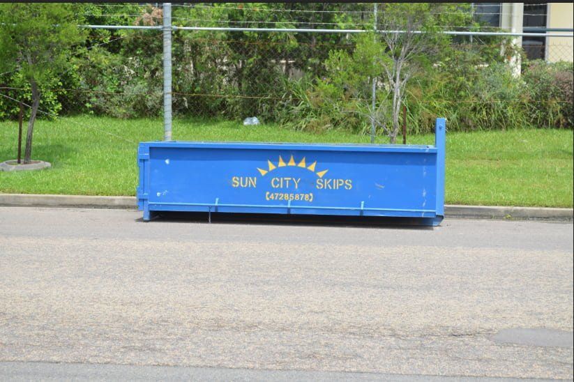 A Blue Dumpster That Says Sun City Skips On It — Sun City Skips In Bohle, QLD