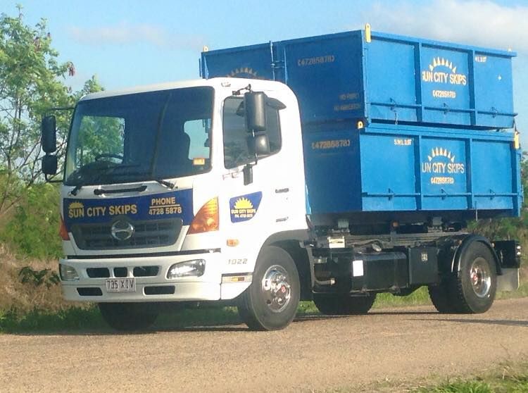 A Sun City Skips Truck Is Parked On A Dirt Road — Sun City Skips In Bohle, QLD