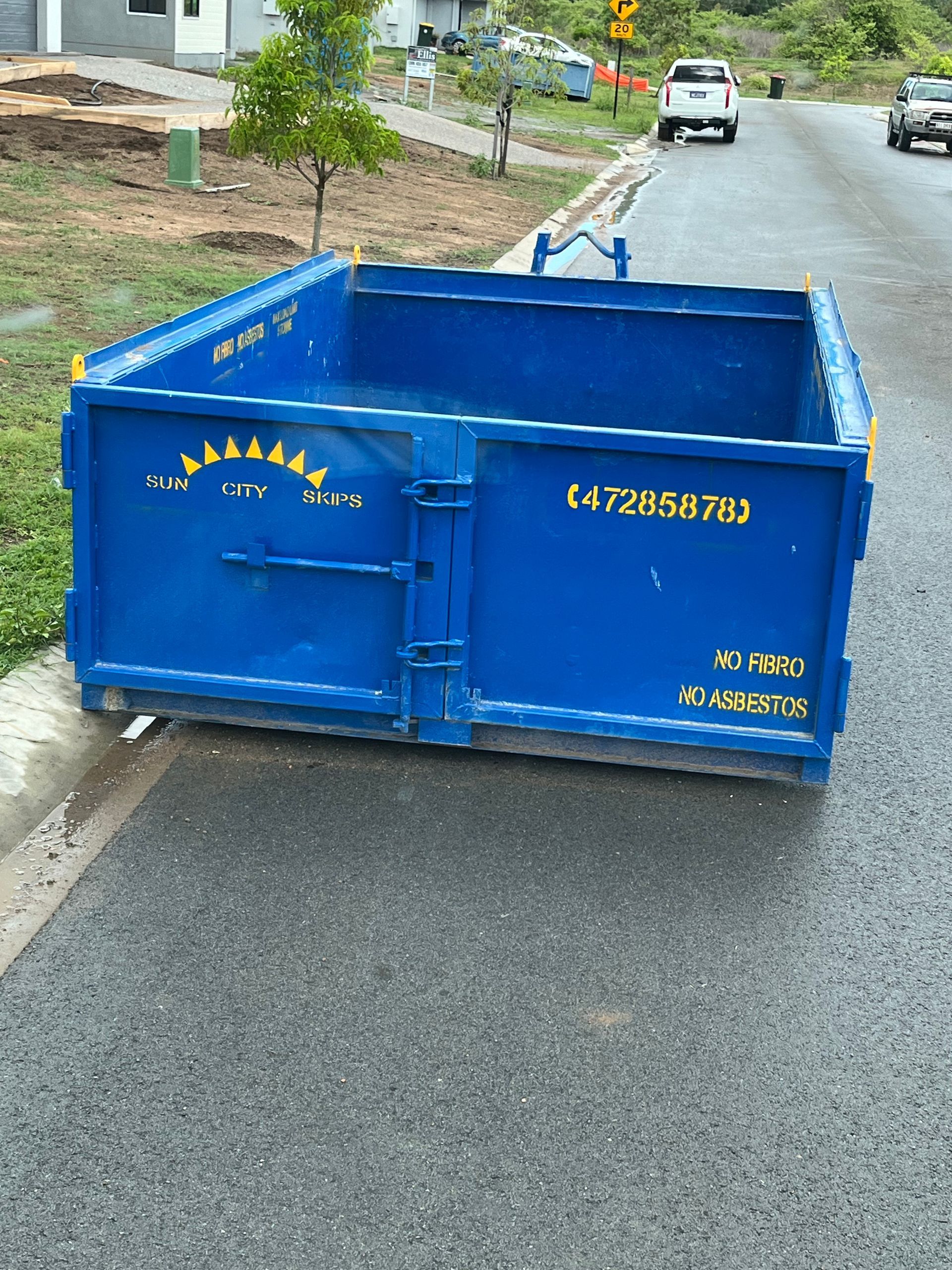 A Dumpster Truck Is Parked On The Side Of The Road — Sun City Skips In Bohle, QLD