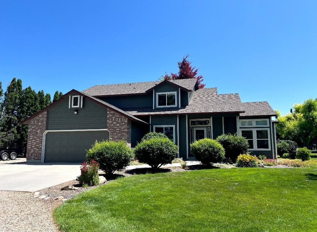 A large house with a lush green lawn in front of it.