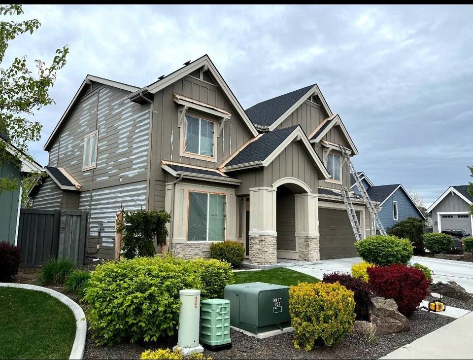 A large house with a lot of windows is sitting on top of a lush green lawn.