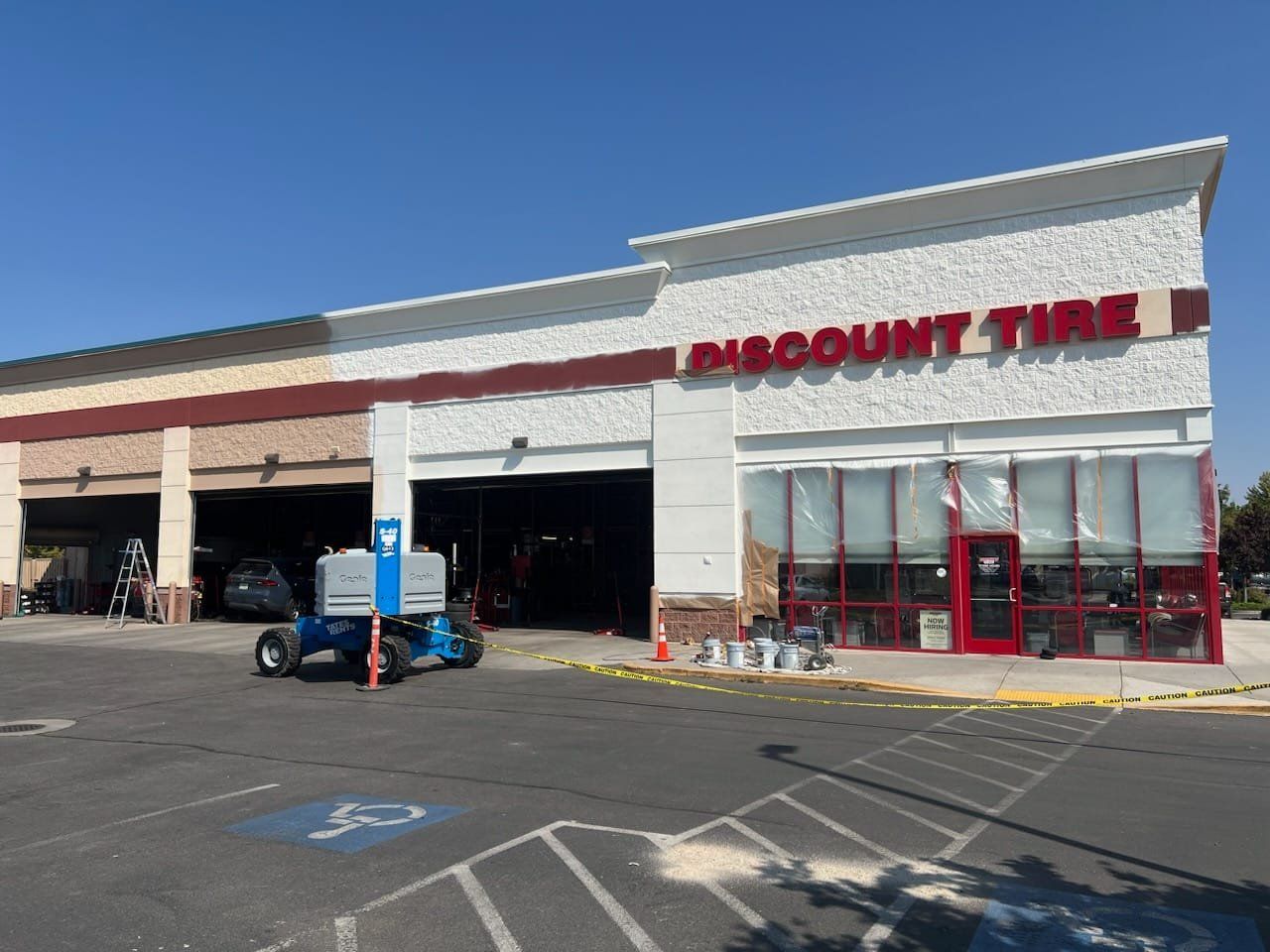 A discount tire store with a handicapped parking spot in front of it