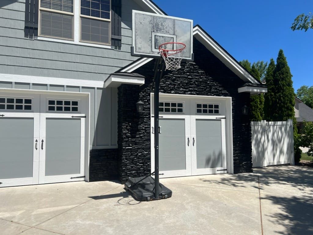 A basketball hoop is in front of a house