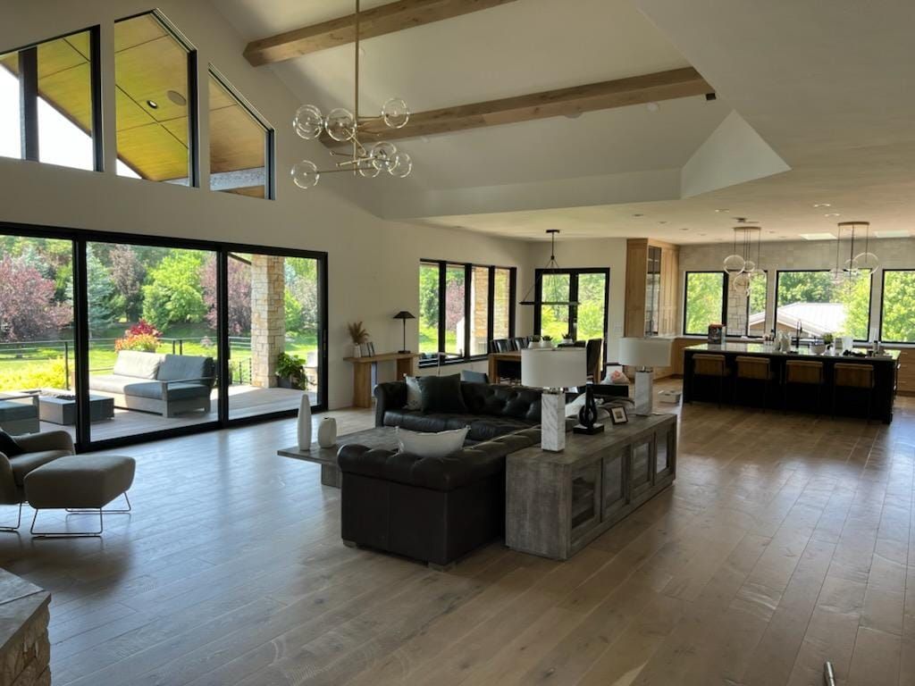 A large living room with a lot of windows and furniture.