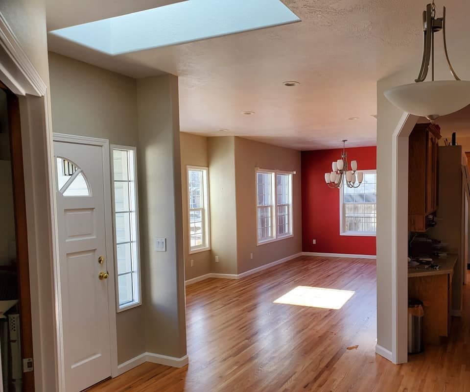 A living room with hardwood floors and a skylight in the ceiling