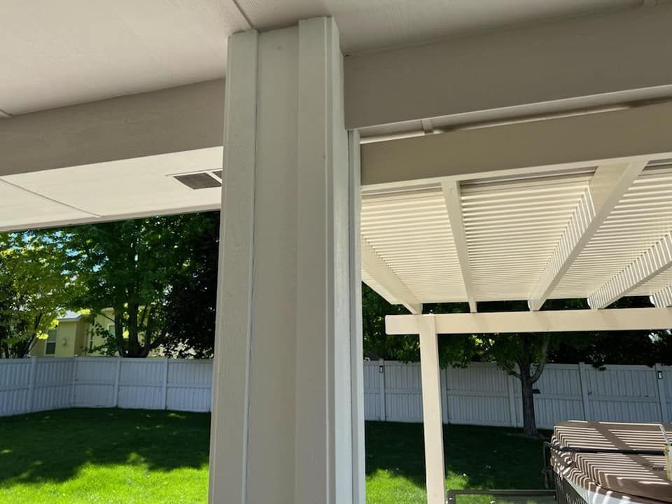 A white pergola with a hot tub underneath it