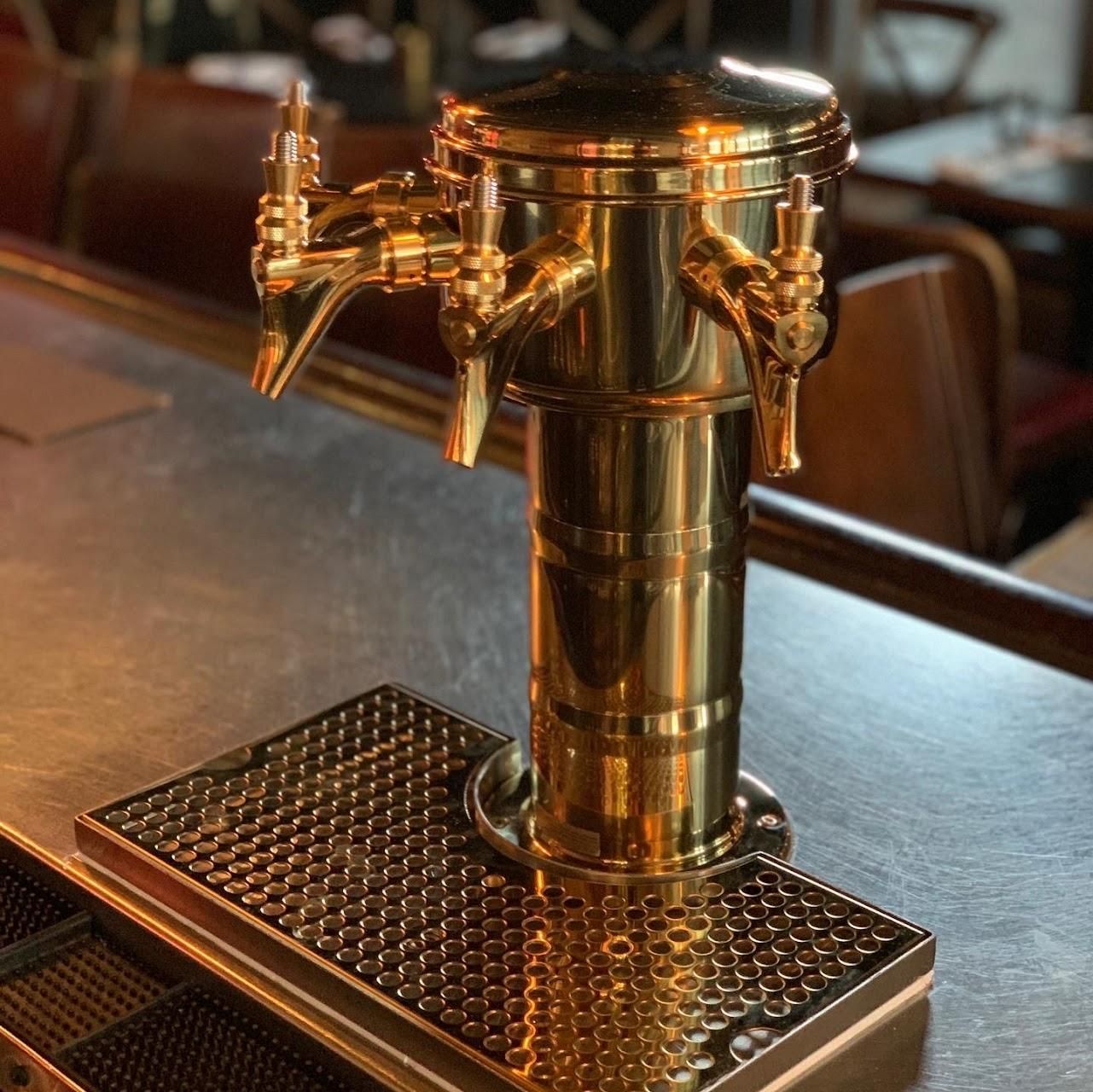 A brass beer tap is sitting on a bar