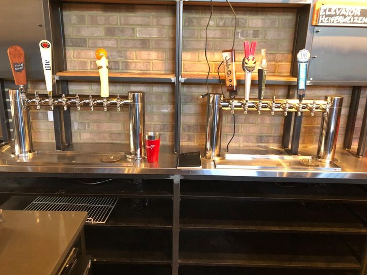 A bar with a lot of beer taps on it