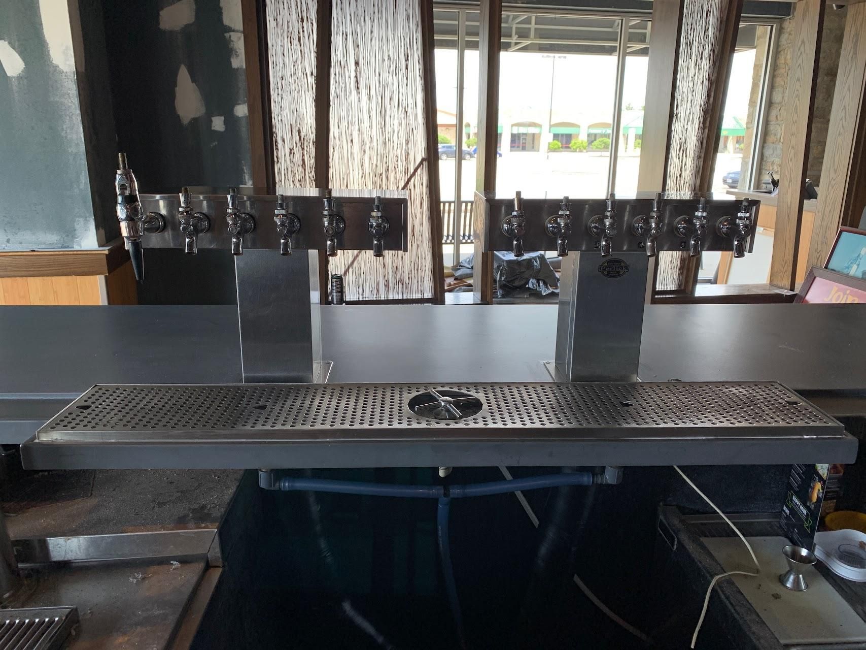 A bar with a lot of taps on it