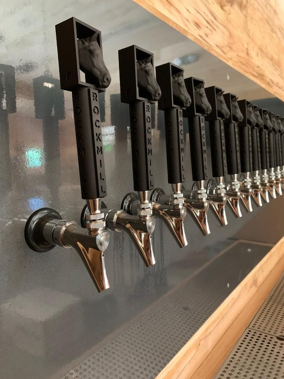 A row of beer taps that say rockmill on them