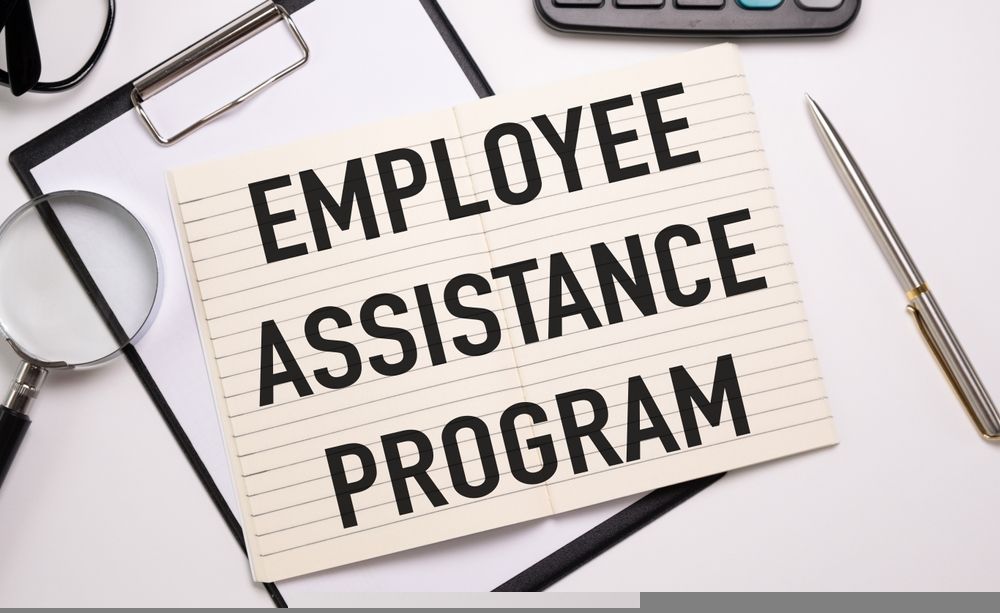 A clipboard with the words `` employee assistance program '' written on it.