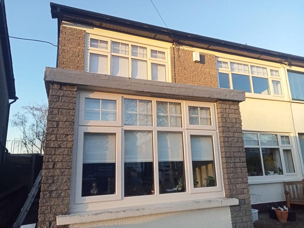 A house with a large window on the side of it