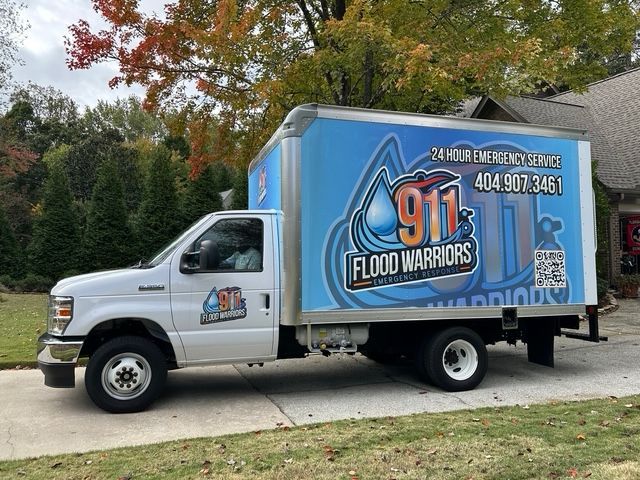 Box truck for 911 Flood Warriors, parked outside. 