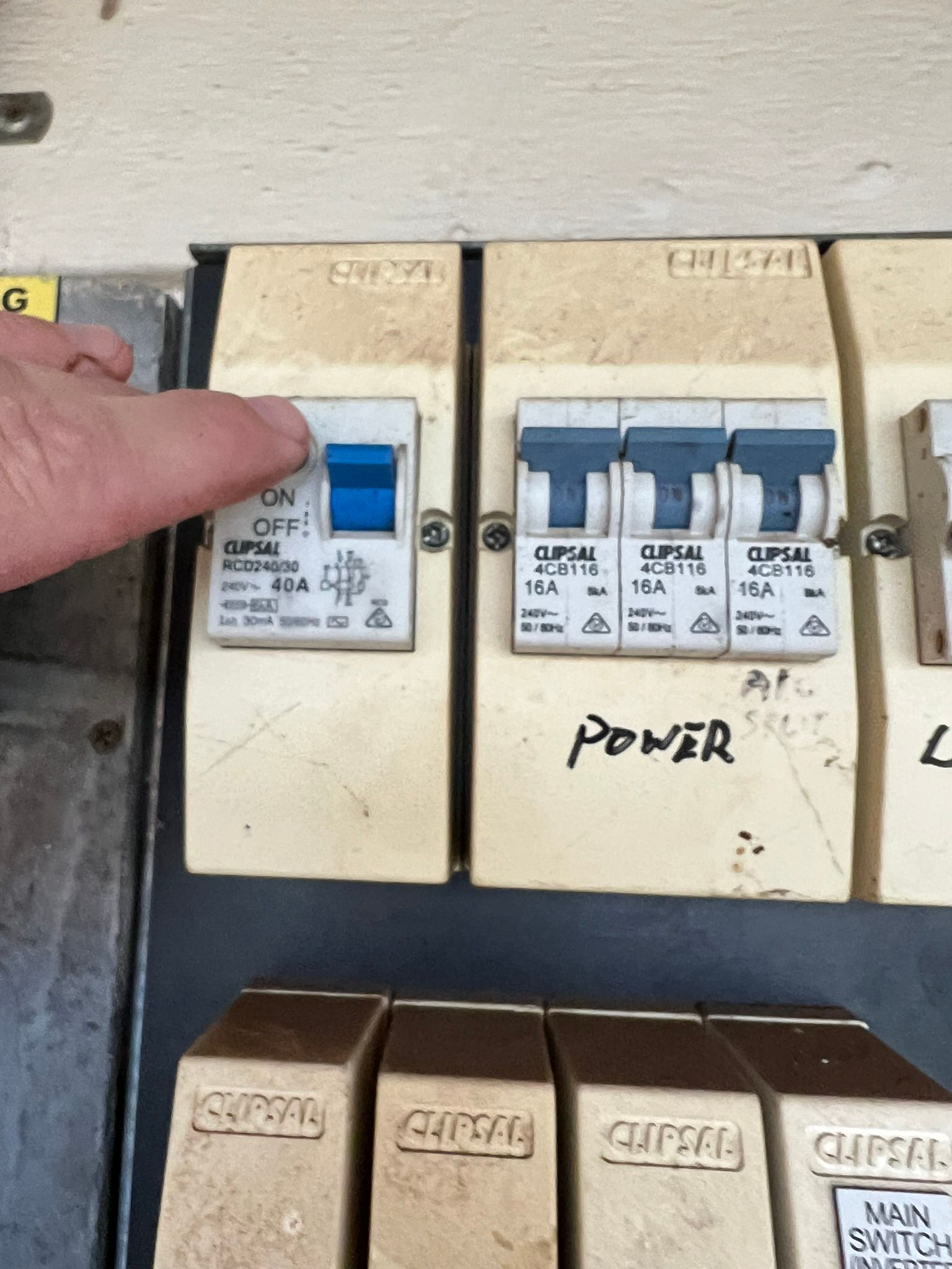 An expert building inspector is testing an RCD safety switch in a Perth electrical board.