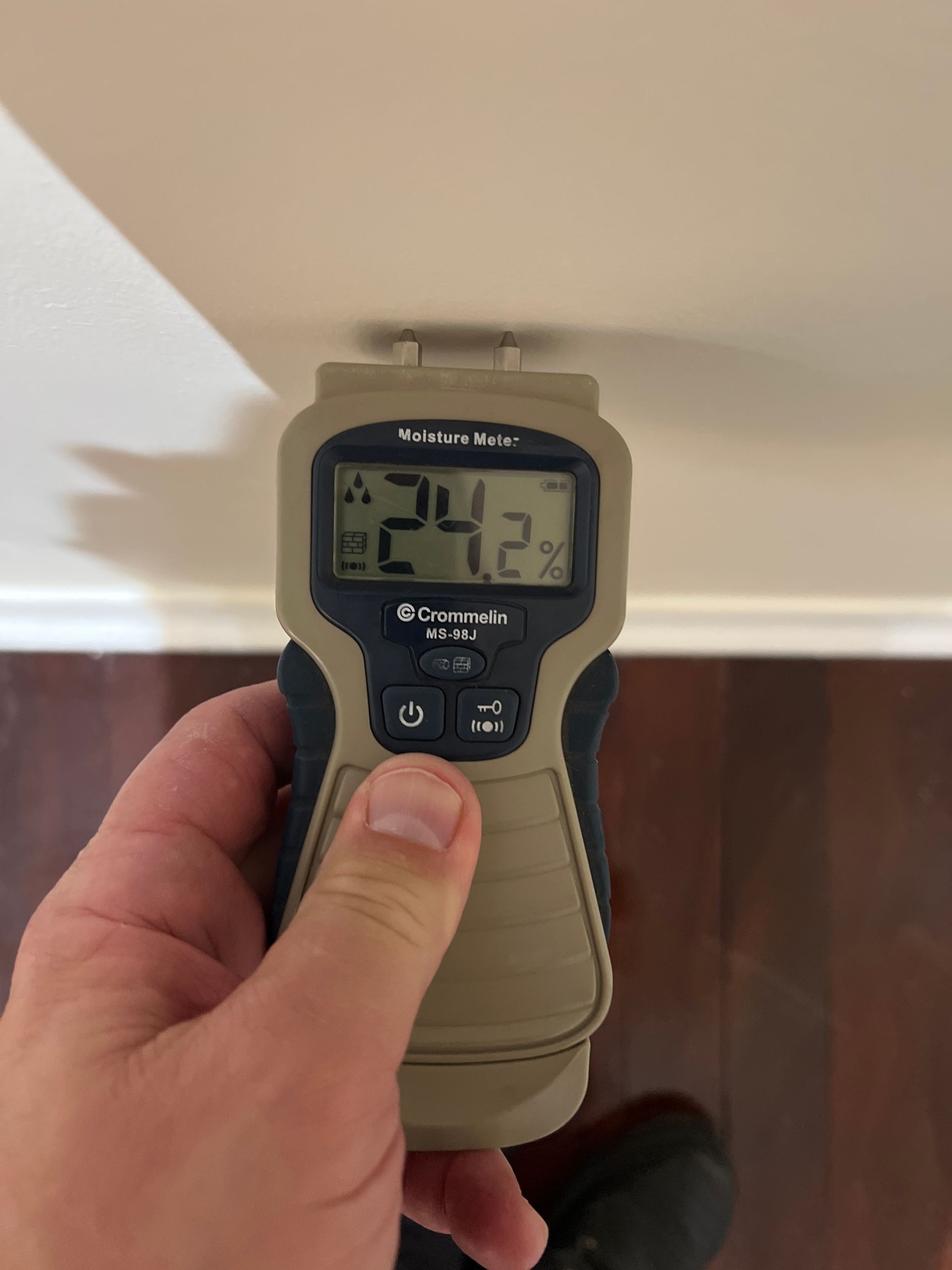 Digital moisture meter detecting rising damp during a Perth building inspection.