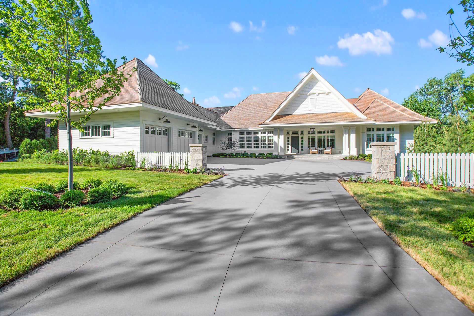 A large white house with a driveway leading to it. — Roswell, GA — Curb Appeal Systems