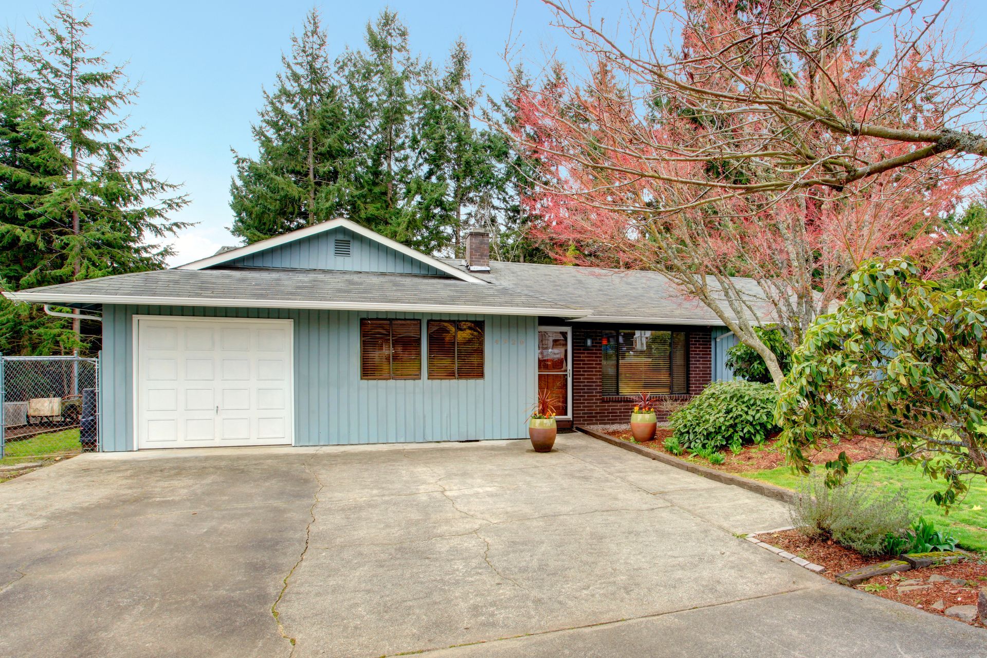 A blue house with a white garage door and a driveway — Alpharetta, GA — Curb Appeal Systems