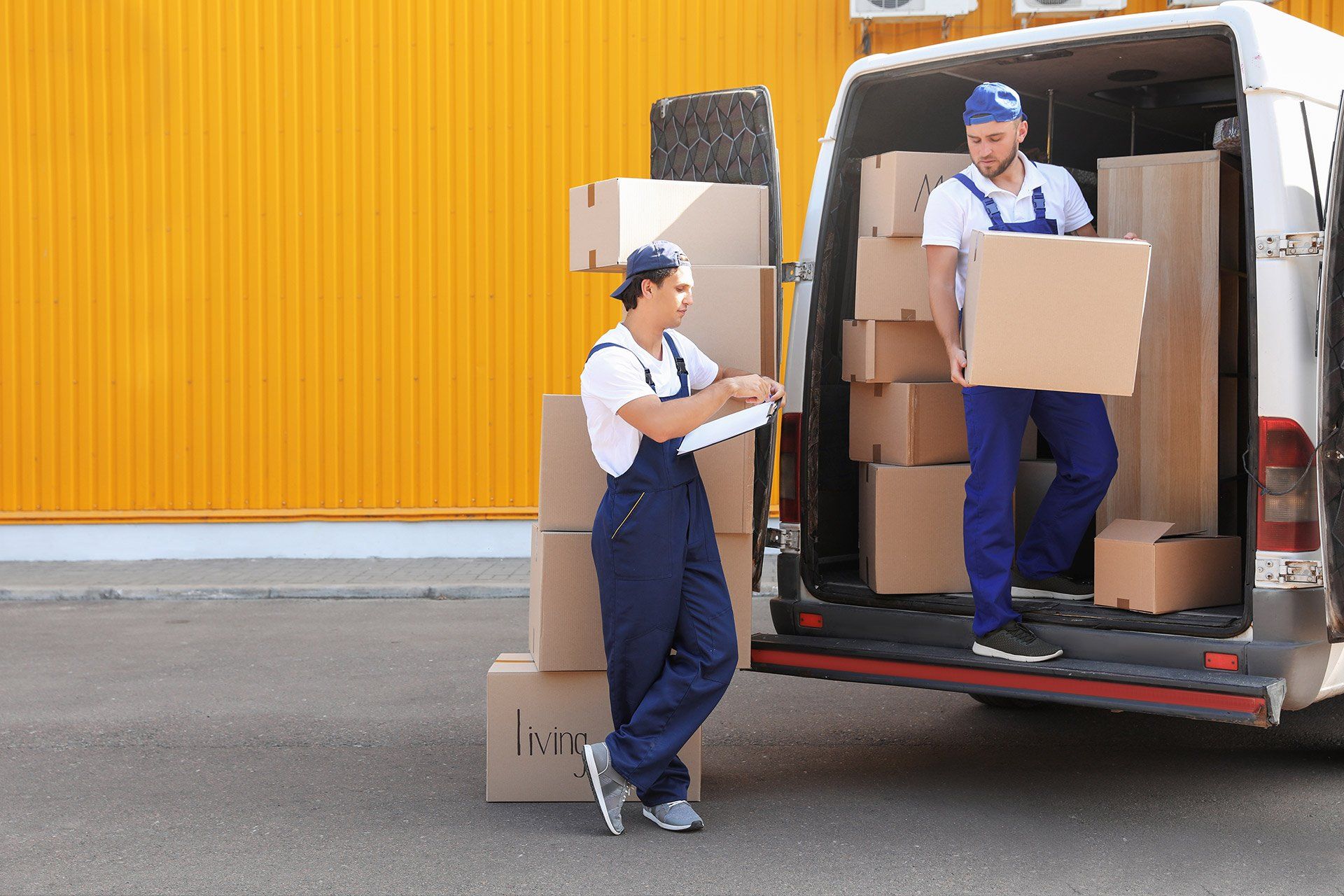 workers unloading boxes from car