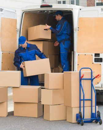 workers unloading boxes off of a truck