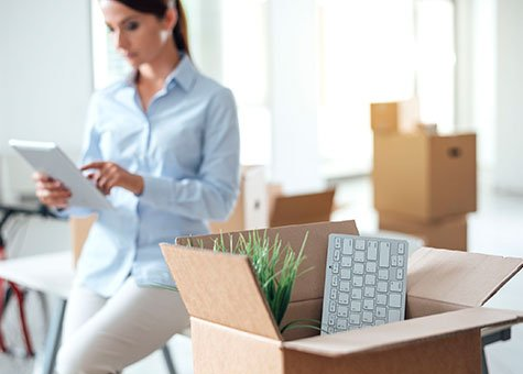 business person in room with boxes of office supplies