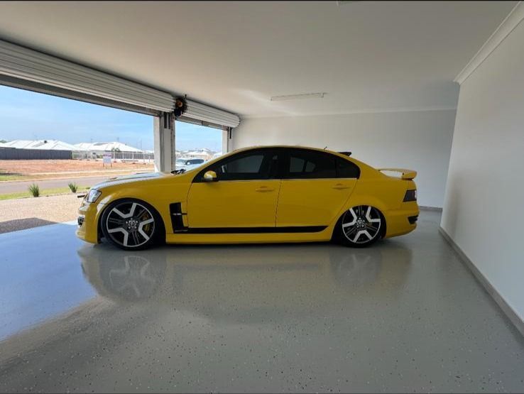 garage with a yellow car and epoxy floor
