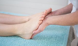 Foot Injury — Doctor Massaging Foot in Murrieta, CA