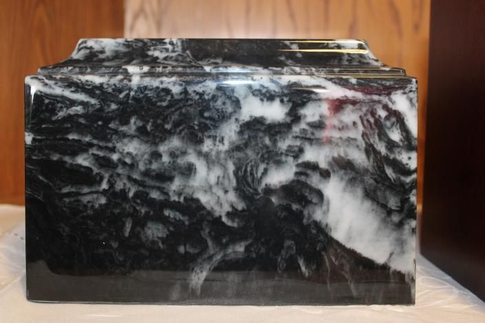 Black and white marble block with polished surfaces on a wooden table