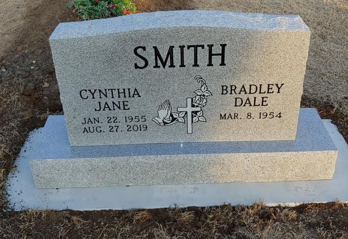 Smith family gravestone with names Cynthia Jane and Bradley Dale in a cemetery.