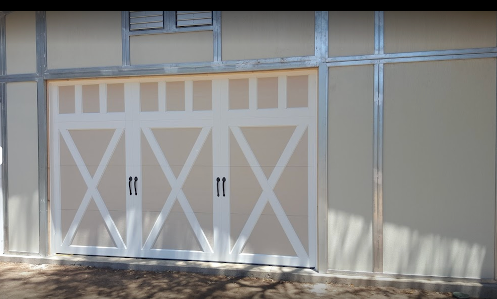 A White and Tan Garage Door with A Metal Frame.