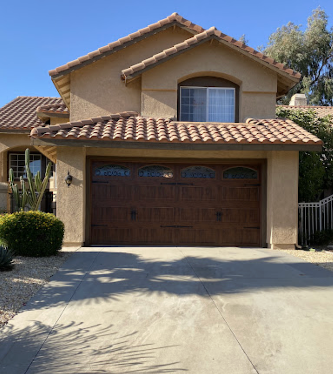A House with A Wooden Garage Door and A Tiled Roof