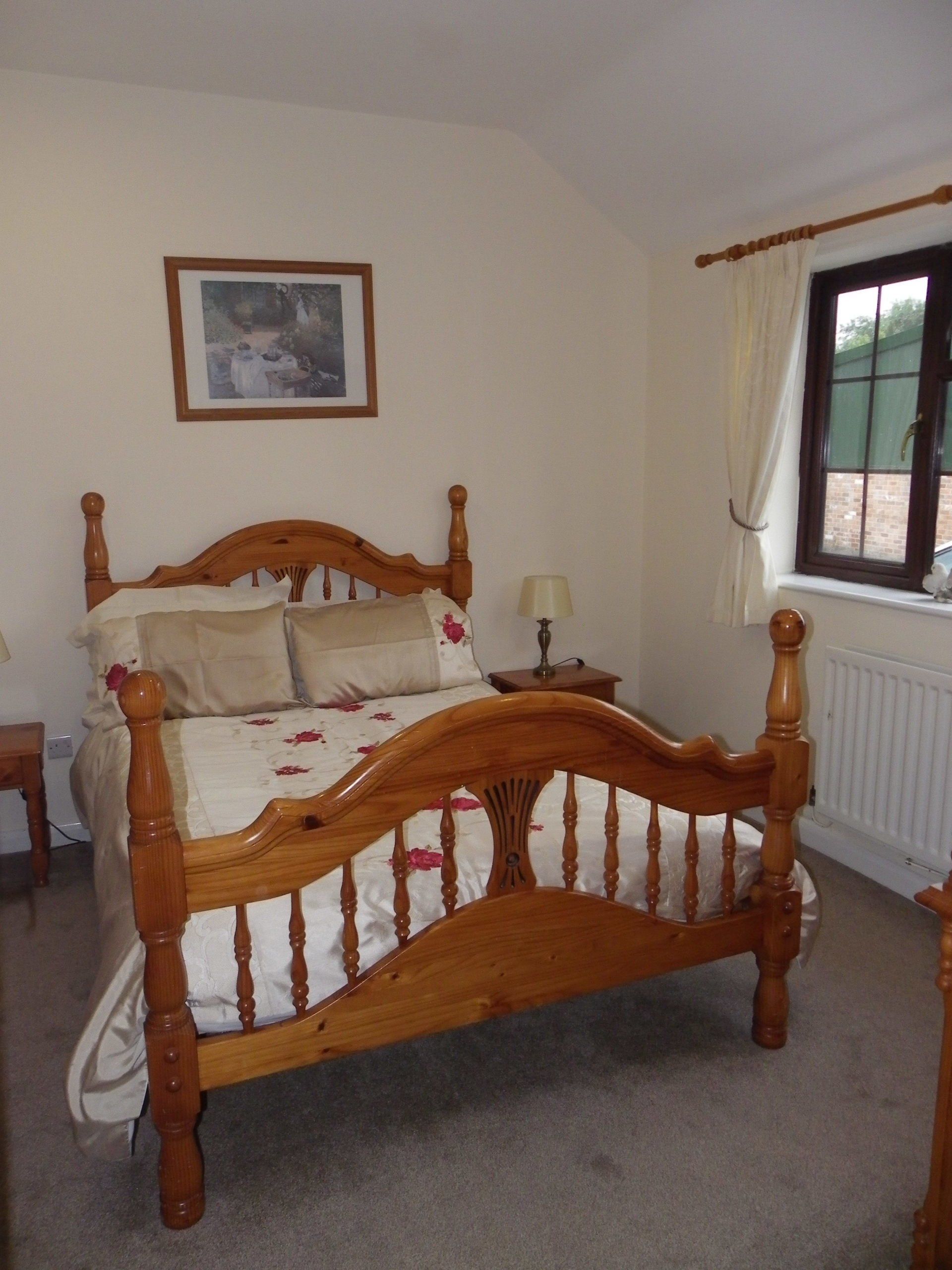 Double bed in Woodpecker cottage near Burnham-on-Sea.