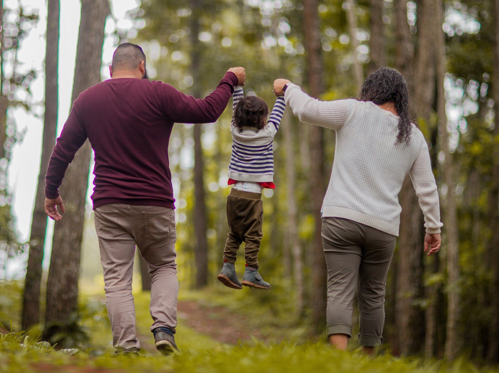 Family who stayed in a holiday cottage having a walk in the woods.