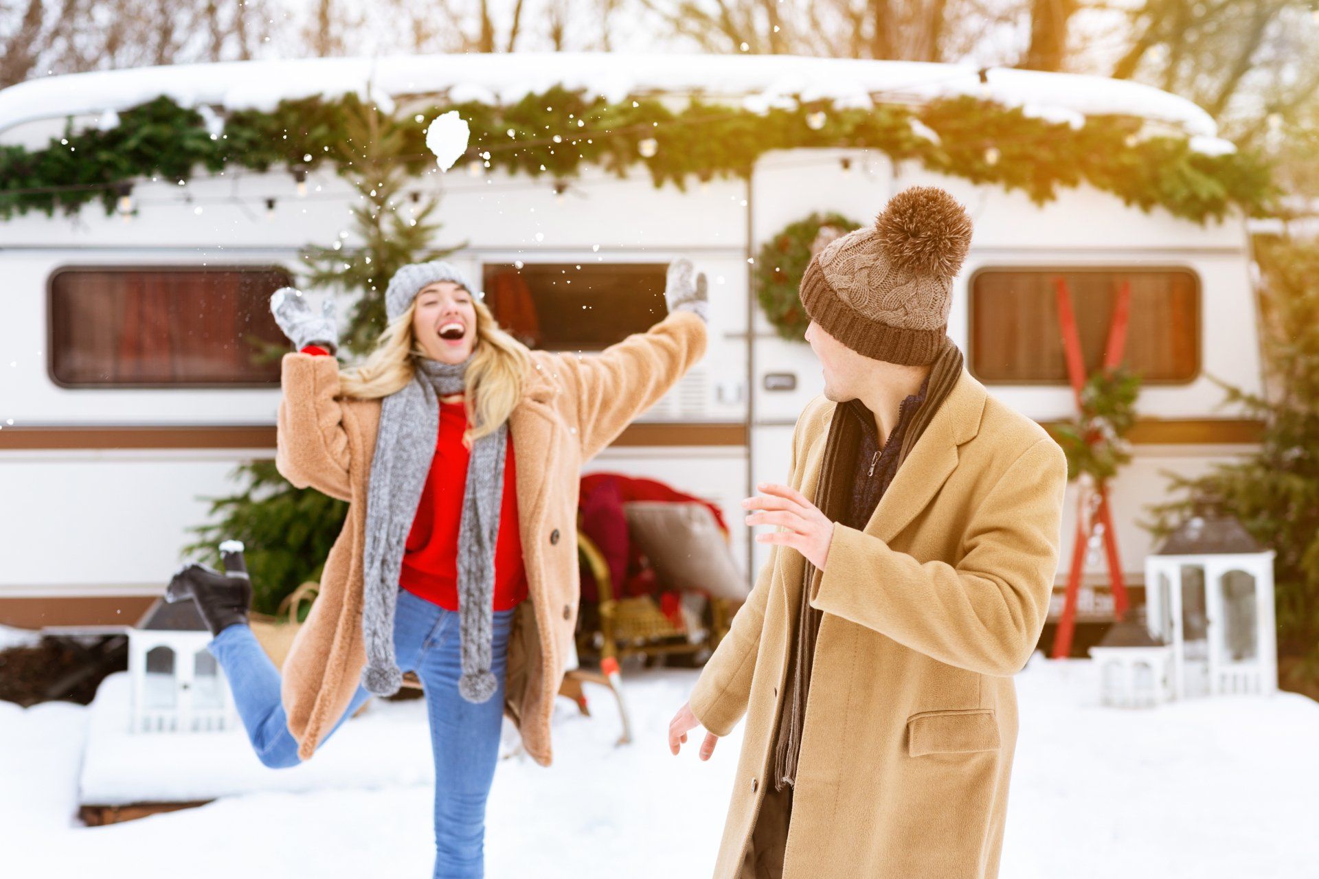 A couple have a snowball fight at a 12-month caravan park