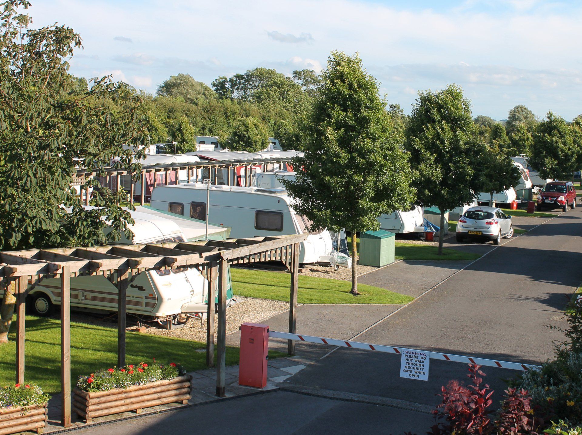 Welcoming Entrance & Caravans Parked in Seasonal Touring Pitches