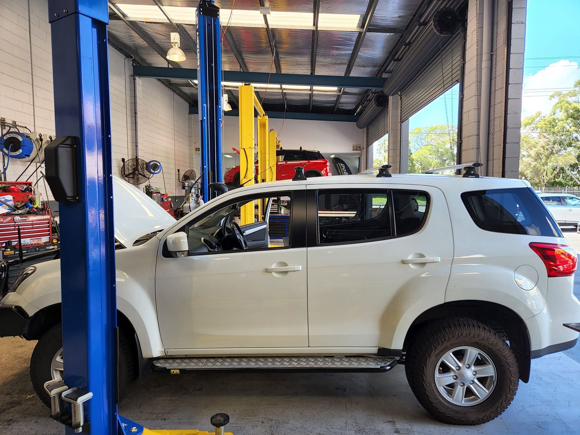 White Suv on a Car Lift Inside a Garage — GZM 4x4 Performance In Ballina, NSW
