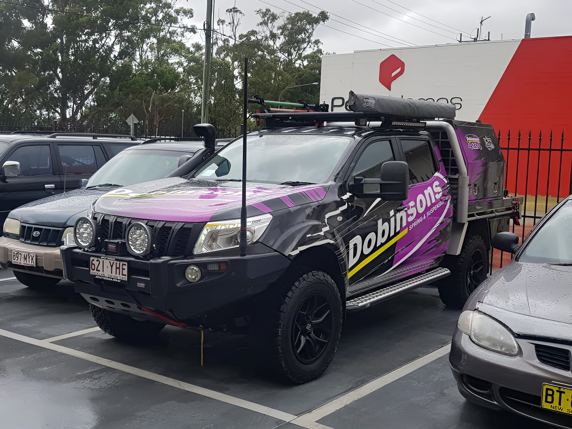 A Purple Truck With the Word Dobinsons on the Side is Parked — GZM 4x4 Performance In Byron Bay, NSW