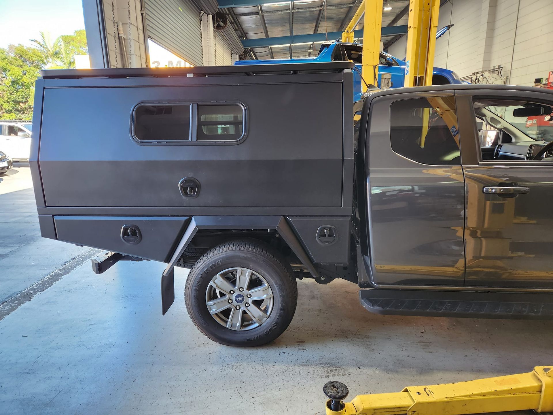 Dark Gray Truck With Matching Canopy and Toolboxes Parked in a Garage — GZM 4x4 Performance In Ballina, NSW