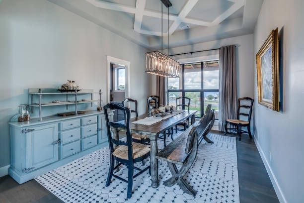 A dining room with a table and chairs and a rug - Wivenhoe, TAS - Summers Floors Pty Ltd