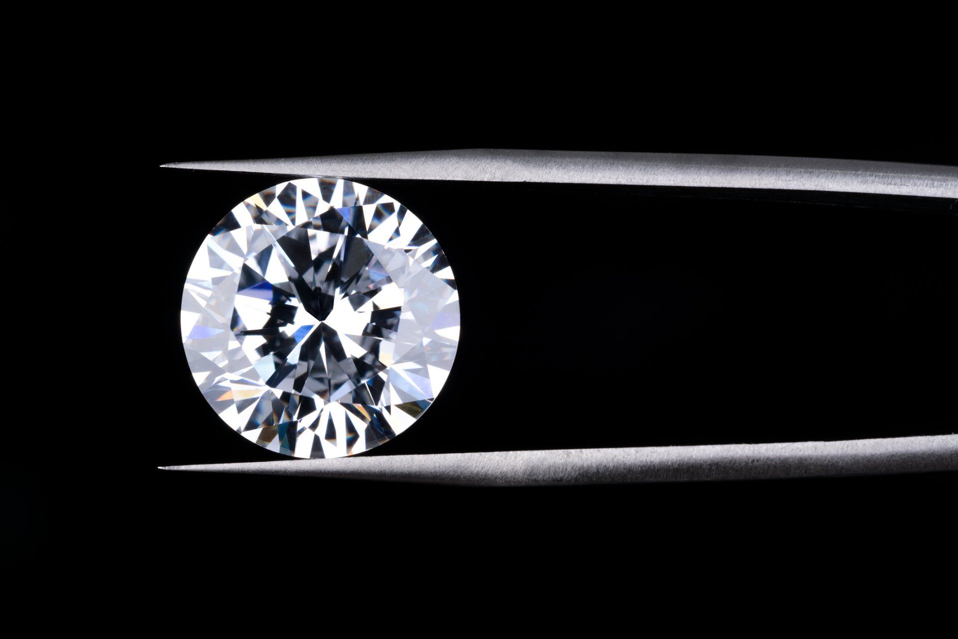 Round Diamond Clamped By Tweezers – Treasure Isle – Raleigh, NC
