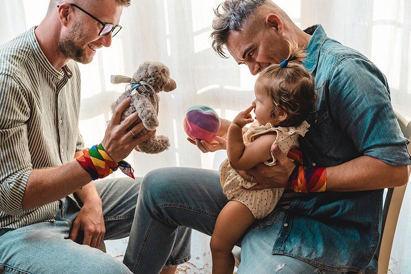 Male Couple with Baby Girl — Tampa, FL — Mark G Rodriguez PA