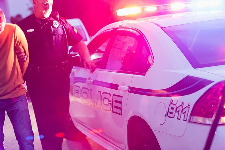 Police Officer Arresting Man at Night — Tampa, FL — Mark G Rodriguez PA