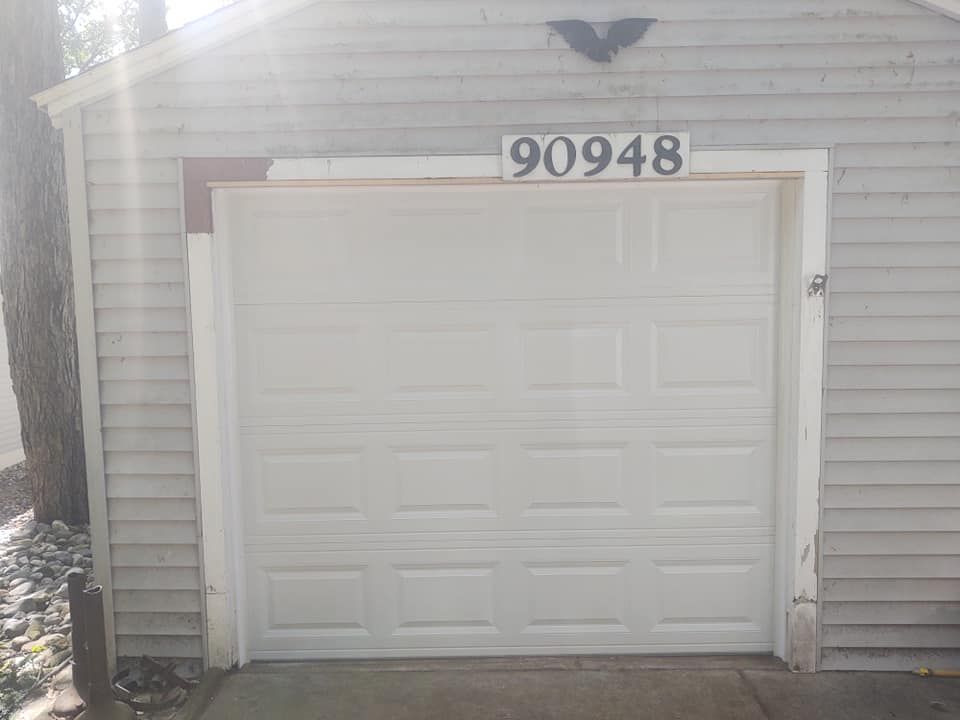 A white garage door with the number 90948 on it.