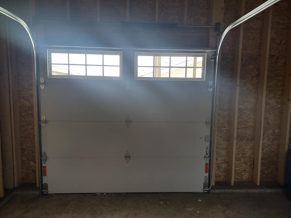 The garage door is open and the sun is shining through it.